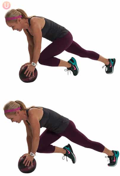Chris Freytag demonstrating a medicine ball mountain climber wearing a black top and workout pants